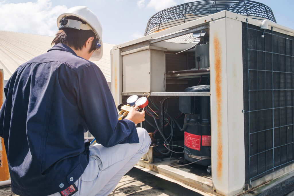 Technician working on commercial condenser unit